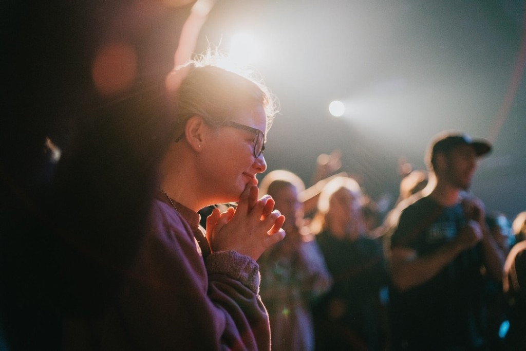 Someone smiling during worship at Words of Life Church